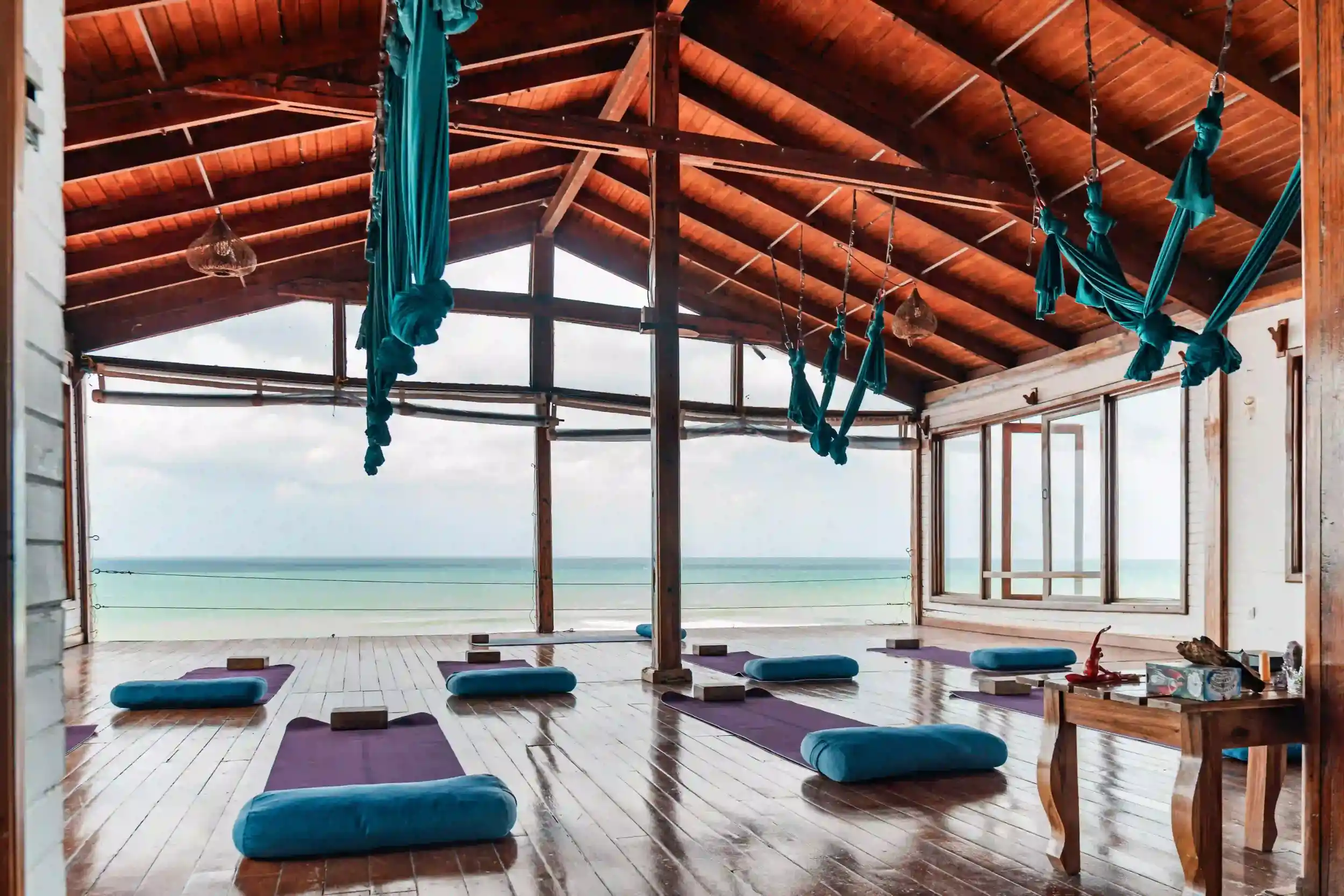 Ocean-view yoga studio at Magnific Rock in Popoyo, Nicaragua, featuring aerial yoga hammocks, wooden floors, yoga mats, and panoramic views